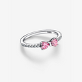 Delikat ring formet som en sløjfe med sølvbånd og pink eller hvide cubic zirconia-sten